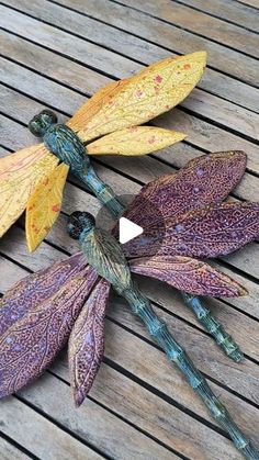 three metal dragon sculptures sitting on top of a wooden table