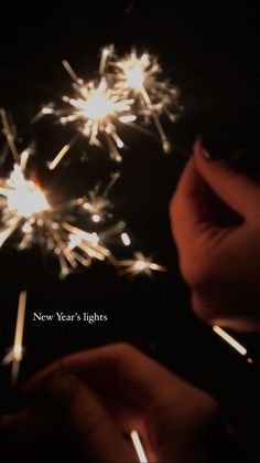 someone holding a sparkler in their hand with the caption new year's lights