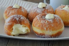 several doughnuts on a plate with cream cheese