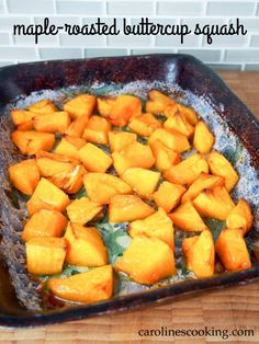 a pan filled with cooked butternut squash on top of a wooden table