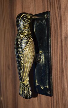 an owl figurine is sitting on the door handle