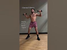 a man with no shirt is holding two dumbbells