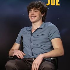 a young man sitting in a chair with his hands on his knees and the words joe above him