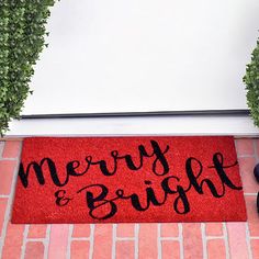 a red door mat that says merry and bright on it next to a pair of black shoes