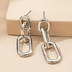 The Chunky Link Style Earrings In Silver Plate Offer A Bold, Modern Twist On Classic Elegance. These Statement Earrings Feature Oversized, Interlocking Links, Plated In Sleek, Polished Silver For A Luxurious, High-Shine Finish. Their Chunky Design Adds A Contemporary Edge, Perfect For Making A Fashion-Forward Statement. Despite Their Substantial Look, They Are Designed To Be Lightweight And Comfortable For All-Day Wear. Versatile And Eye-Catching, These Earrings Are Perfect For Elevating Both Ca Modern Jewellery Design, Alloy Earrings, Link Earrings, Chain Design, Watches Women Fashion, Trendy Gift, Silver Drop Earrings, Elegant Earrings, Modern Jewelry