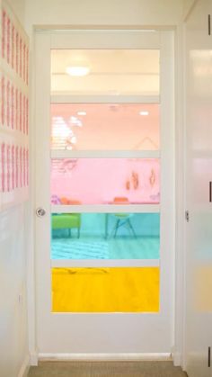 an open door leading to a brightly colored room