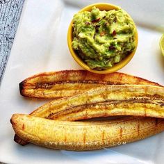 some bananas are on a white plate with guacamole