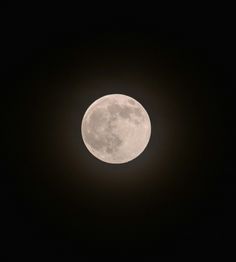 the full moon is seen in the dark sky with no clouds on it's side