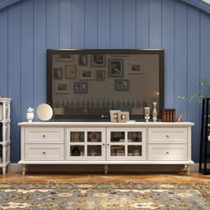 a living room scene with focus on the entertainment center and rug in the foreground