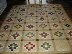 a large quilt on the floor in a living room