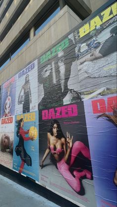 a large poster on the side of a building in front of a woman's body