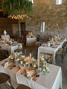 the tables are set up with candles and flowers on them for an elegant dinner party