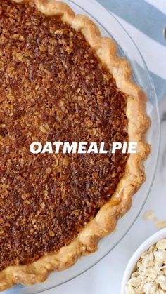 a pie sitting on top of a table next to a bowl of oatmeal