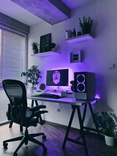 a desk with two computer monitors and speakers on it