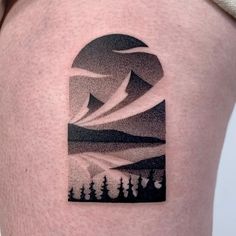 a man's thigh with a mountain scene tattoo on his left side ribcage