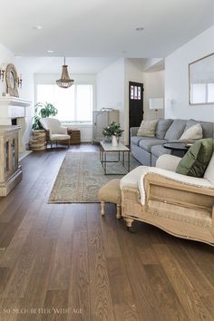 a living room filled with furniture and a fire place in the middle of a room