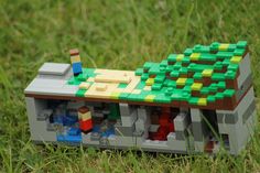 a toy boat made out of legos in the grass