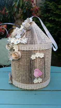 a birdcage made out of wicker sitting on top of a blue table