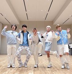 group of young men standing in an empty room