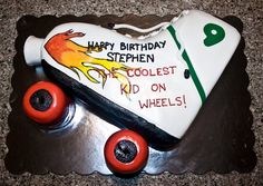 a birthday cake shaped like a skateboard with wheels