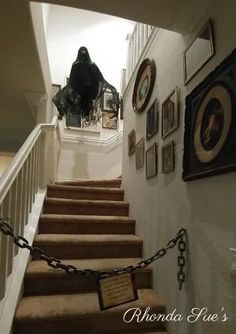 there are pictures on the wall next to the stairs