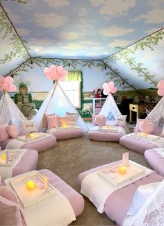 a room filled with lots of pink furniture and decor on top of carpeted flooring