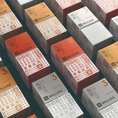 many boxes with chinese writing on them are lined up in the shape of cubes