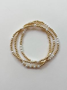 these super sweet and dainty gold and pearl bracelets are perfect for everyday wear! each one is custom made just for YOU! select your size and choose your style from the options shown. PLEASE NOTE: you will receive ONE bracelet with this order unless you choose the option for the set of all three. MADE WITH GOLD FILL BEADS - "gold fill" beads are high quality and they don't tarnish or fade like "gold plated" beads. the difference is a long-lasting premium piece of jewelry that is perfect for everyday wear. these super trendy and versatile stretch bracelets are the perfect little accessory for your wrist. they are dainty and beautiful by themselves, but also look great when combined and stacked. you can add to your stack right here: http://www.etsy.com/shop/letterhappy?section_id=7484094 t Beaded Bracelets Pearl, Dainty 14k Gold-filled Stretch Bracelet, Pearl And Gold Bracelet, Gold Stacked Bracelets, Trendy Beaded Jewelry, Gold And Pearl Bracelet, Gold Bracelet Stack, Neutral Jewelry, Gold Bead Bracelet