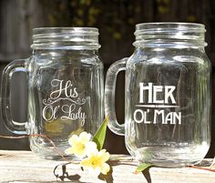 two mason jars with the words her and her oh man painted on them, sitting next to each other