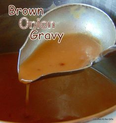 a spoon full of brown onion gravy in a saucepan with the words, brown onion gravy