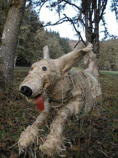 a dog made out of burlocks in the woods