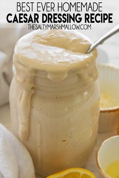 the best ever homemade caesar dressing recipe in a mason jar with lemons and orange slices