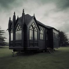 a small black building sitting on top of a lush green field under a cloudy sky