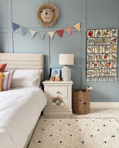 a bed room with a neatly made bed and a stuffed animal on the headboard