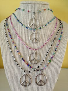 ** PLEASE NOTE - I'm making a bunch in different colors If you want a custom color/length necklace or like one that shows sold, let me know and a custom necklace can be made for you These necklaces are made with glass seed beads. The silver metal peace sign charm is 1-1/8 inch in height and 1 inch in width. The necklace is 19-1/2 inches long. The beads are strung on nylon coated steel wire with a lobster claw closure. It can also be worn as an anklet because the necklace will wrap around the ank Personalized Round Beads Jewelry For Festival, Personalized Festival Jewelry With Round Beads, Collar Hippie, Hippie Crafts, Peace Necklace, Peace Sign Necklace, Sign Necklace, Estilo Hippie, Jupiter Fl