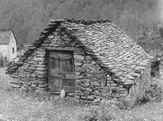 black and white photograph of an old stone house