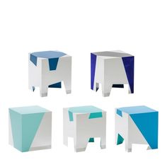 four different colored stools sitting next to each other on a white surface with blue and green accents