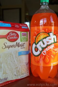 a bottle of crush orange juice next to a package of crumbs on a table