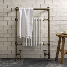 a white towel is hanging on an old fashioned radiator