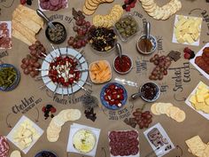 a table topped with lots of different types of cheeses and crackers on top of it