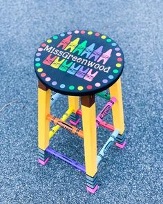 a toy stool with the words missgreenwood on it sitting in the middle of a parking lot