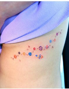 a woman's stomach with the planets and stars on her side ribcage