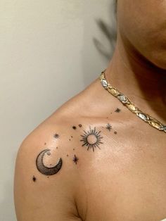 a woman's chest with stars and the moon on her left side, tattoo style