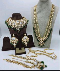 an assortment of jewelry is displayed on a mannequin