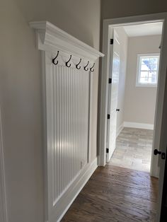 the entryway is clean and ready to be used as a coat rack for coats