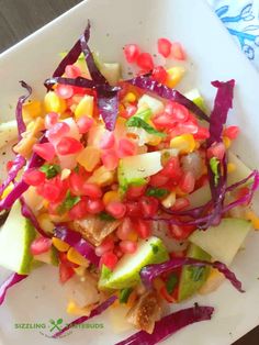 a white plate topped with fruit and veggies