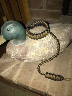 a statue of a duck with a snake in its beak on top of a rock