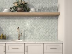 a kitchen with white cupboards and shelves filled with dishes on top of each other