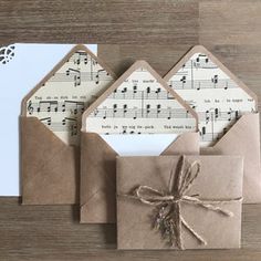 three envelopes with sheet music on them and tied in twine to each other