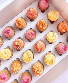 a box filled with lots of colorful cupcakes